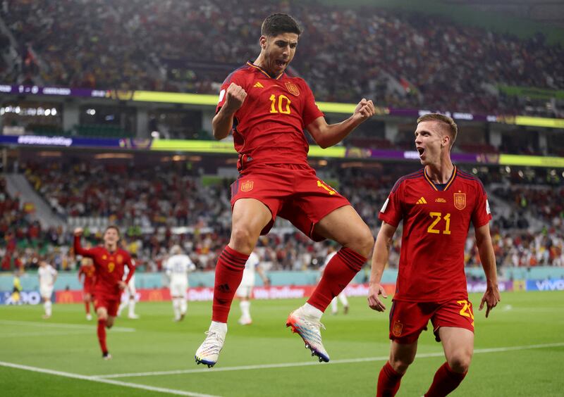 Spain's Marco Asensio celebrates scoring their second goal with Dani Olmo. Reuters