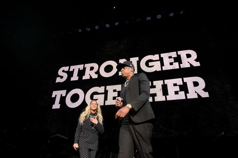 (FILES) In this file photo taken on November 4, 2016 Beyonce (L) and Jay-Z introduce Democratic presidential nominee Hillary Clinton during a Get Out the Vote (GOTV) performance in support of her at the Wolstein Center in Cleveland, Ohio. Music's most famous couple Beyonce and Jay-Z pulled a surprise by releasing a joint album late on June 16, 2018, a long-rumored collaboration that celebrates their marital passion. / AFP / Brendan Smialowski
