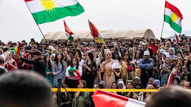 People gather with the Kurdish flag during a Syrian Kurdish celebration marking Nowruz in the town of Qahtaniyah. AFP