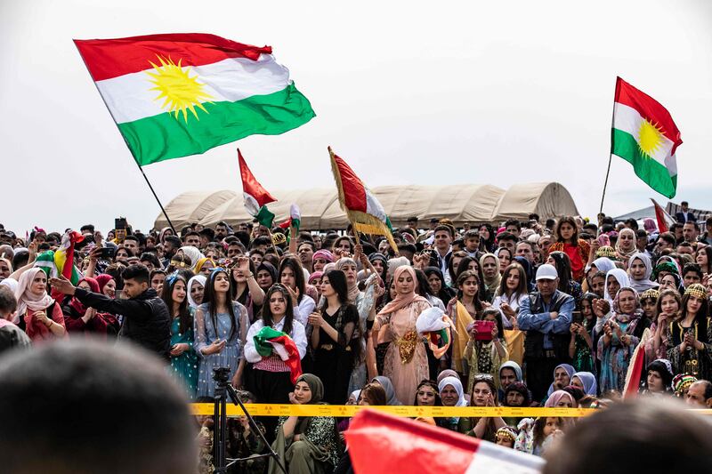 People gather with the Kurdish flag during a Syrian Kurdish celebration marking Nowruz in the town of Qahtaniyah. AFP