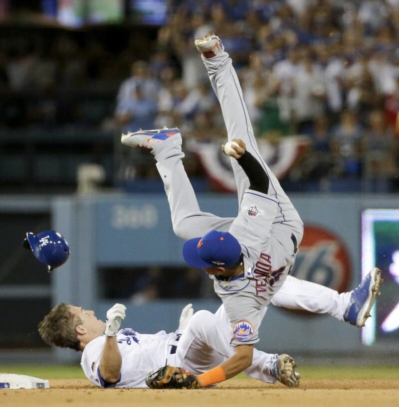New York Mets shortstop Ruben Tejada, goes over the top of Los Angeles Dodgers’ Chase Utley who broke up a double play during the seventh inning in Game 2 of baseball’s National League Division Series. Gregory Bull / AP Photo