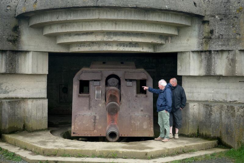 People look at the German guns at the battery at Longues-sur-Mer in Normandy.