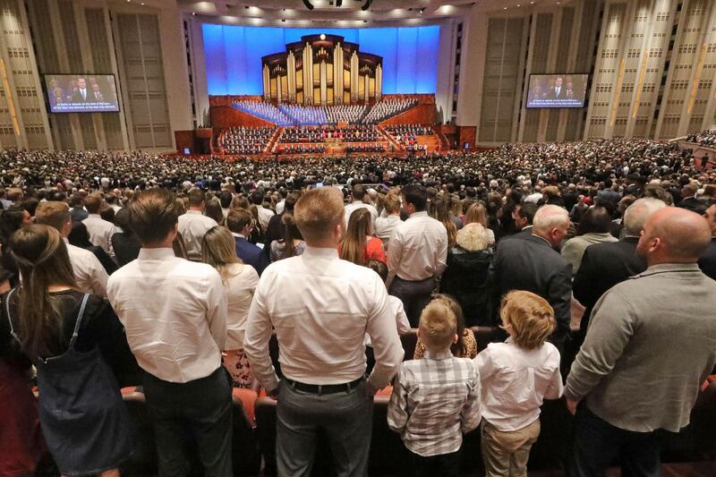 FILE - In this Oct. 5, 2019, file photo, people listen during The Church of Jesus Christ of Latter-day Saints' twice-annual church conference, in Salt Lake City. For the first time in more than 60 years, top leaders from The Church of Jesus Christ of Latter-day Saints will deliver speeches at the faith's signature conference this weekend without anyone watching in the latest illustration of how the coronavirus pandemic is altering worship practices around the world. The twice-yearly conference normally brings some 100,000 people to the church conference center in Salt Lake City to watch five sessions over two days. This event, though, will be only a virtual one. (AP Photo/Rick Bowmer, File)