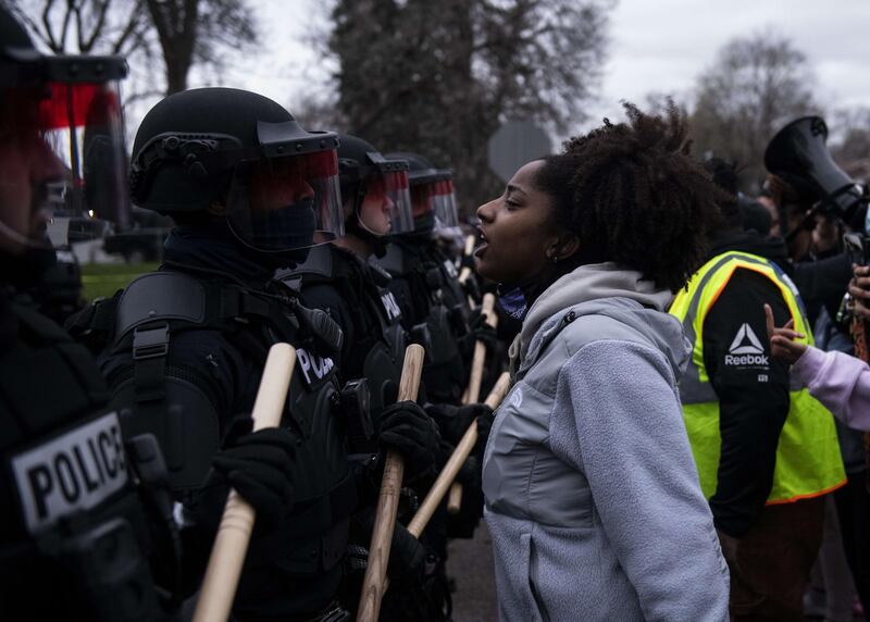 Protesters confront law enforcement officers in Brooklyn Centre, Minnesota, after police reportedly shot and killed Daunte Wright during a traffic stop earlier in the day. AFP
