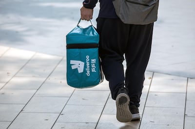 A Deliveroo food delivery worker carries an insulated food bag in Hong Kong, China, on Thursday, Feb. 20, 2020. A group of 59 Hong Kong police officers are being quarantined after a fellow officer preliminarily tested positive for the virus, the city’s police force said in a statement on Facebook. Photographer: Paul Yeung/Bloomberg