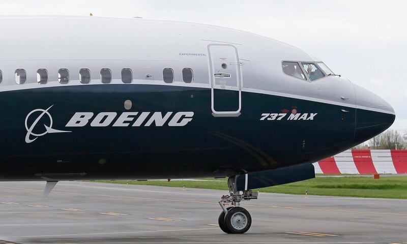 FILE - In this April 13, 2017, file photo, a pilot waves from the flight deck of a Boeing 737 MAX 9 as it rolls out for the airplane's first flight, in Renton, Wash.   A temporary injunction freezing a joint venture between airplane manufacturers Boeing and Embraer has been overruled by a Brazilian justice.  The ruling was made Saturday, Dec. 22, 2018 by Federal Court President Therezinha Cazerta, who said that the matter is outside the court's purview. 
(AP Photo/Ted S. Warren, File)