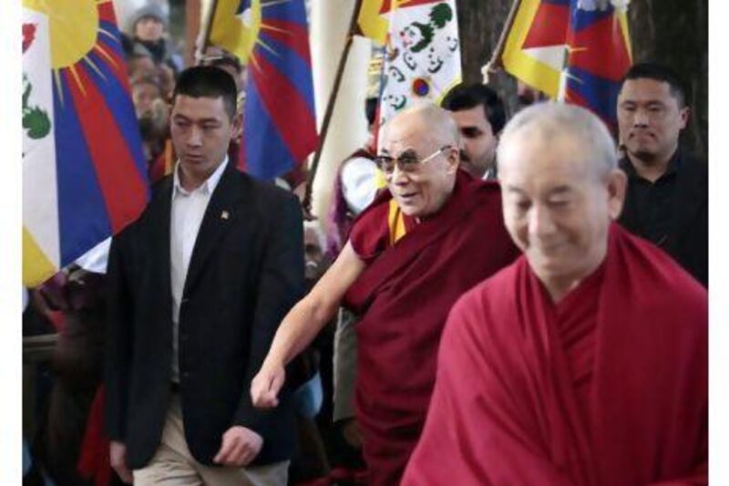 The Dalai Lama (centre) is to give up his political role in Tibet's government-in-exile, shifting that power to an elected representative.