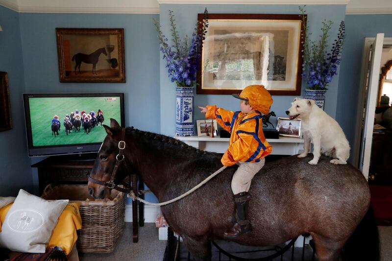 Horse Racing - Merlin Coles 3, watches the horse racing from Royal Ascot on TV at his home - Bere Regis, Britain - June 17, 2020  Merlin Coles 3, watches the horse racing from Royal Ascot on TV at his home, whilst sat on his horse Mr Glitter Sparkles with his dog Mistress, in Bere Regis, Dorset, as racing resumed behind closed doors after the outbreak of the coronavirus disease (COVID-19)  REUTERS/Paul Childs     TPX IMAGES OF THE DAY