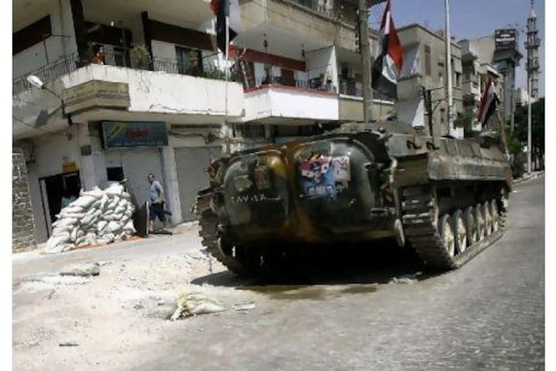 A Syrian tank takes position in a residential street in Homs on Tuesday, as activists reported widespread anti-regime protests across Syria.
