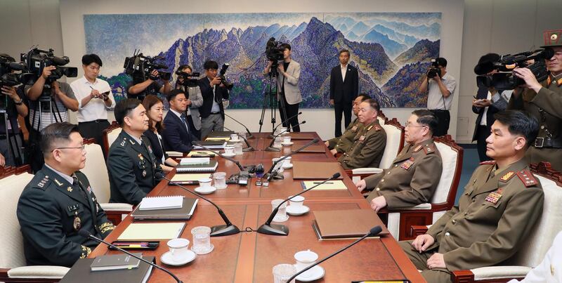 A handout photo made available by the South Korean Ministry of National Defense shows South Korea's chief delegate Major Gen. Kim Do-gyun (2-L) speaking with his North Korean counterpart Lt. Gen. An Ik-san (2-R) during the high-level inter-Korean military meeting at the Peace House on the southern side of the border truce village Panmunjom in Paju, South Korea.  EPA / MINISTRY OF NATIONAL DEFENSE