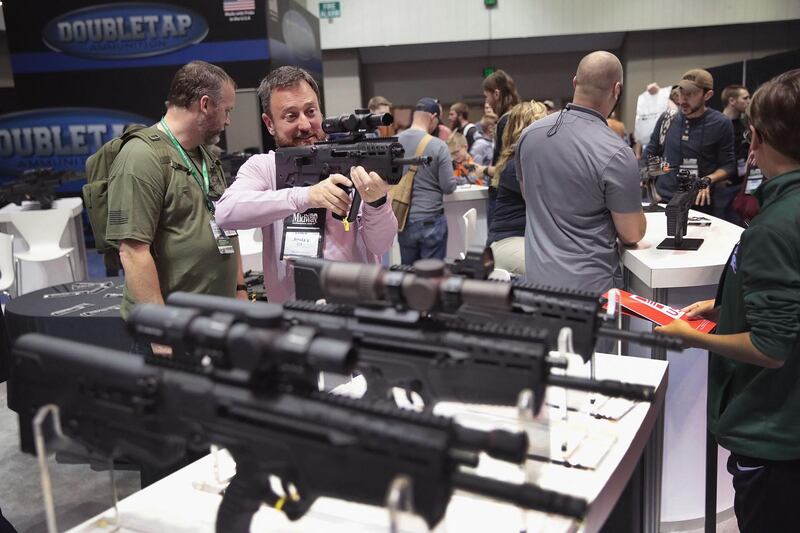 INDIANAPOLIS, INDIANA - APRIL 27: Guests shop for firearms and accessories at the 148th NRA Annual Meetings & Exhibits on April 27, 2019 in Indianapolis, Indiana. The convention, which runs through Sunday, features more than 800 exhibitors and is expected to draw 80,000 guests.   Scott Olson/Getty Images/AFP (Photo by SCOTT OLSON / GETTY IMAGES NORTH AMERICA / Getty Images via AFP)
