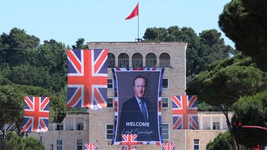 A portrait of British Foreign Secretary David Cameron is attached on a facade at the Tirana University, in Tirana, Albania. AP