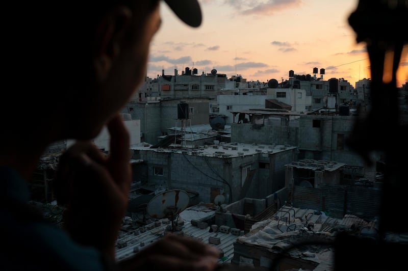 A boy looks out of the window as the sun sets in Gaza City. Ever since Hamas launched demonstrations in March against Israel's blockade of Gaza, children have been a constant presence in the crowds. Since then, U.N. figures show that 948 children under 18 have been shot by Israeli forces and 2,295 have been hospitalized, including 17 who have had a limb amputated. AP