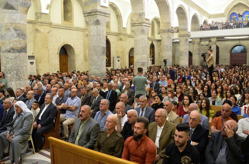 Iraqi Catholic Christians attend Easter Sunday mass at Qaraqosh's Al Tahera (Immaculate Conception) Church in the Hamdaniyah district of Nineveh on Sunday. AFP