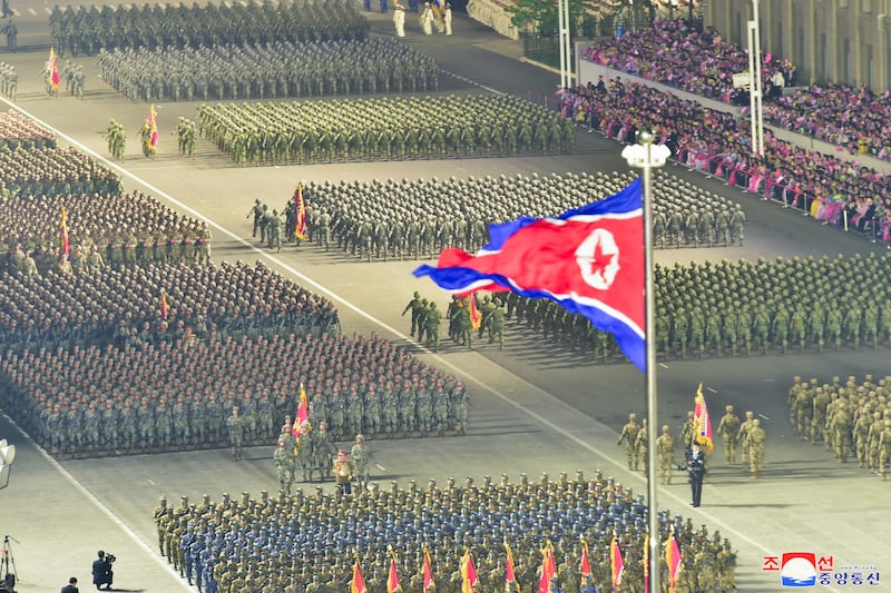 Troops on parade as the national flag flutters in Pyongyang. EPA