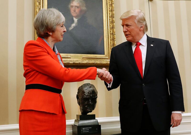 FILE - This is a Friday, Jan. 27, 2017 file photo of US President Donald Trump as he shakes hands with British Prime Minister Theresa May in the Oval Office of the White House in Washington. British Prime Minister Theresa May  insisted on Thursday Nov. 30, 2017 th that she is not afraid to criticize a key ally, saying U.S. President Donald Trump's retweets of a "hateful" far-right group were "the wrong thing to do." But May's government dug in its heels over mounting calls to cancel Trump's planned state visit to the U.K. Trump's retweeting of anti-Muslim videos from far-right fringe group Britain First has been widely condemned in Britain. (AP Photo/Pablo Martinez Monsivais, File)