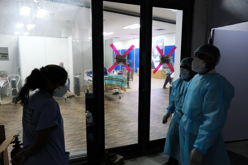 Health workers outside a Covid-19 ward set up at the Commonwealth Games Village Sports Complex in New Delhi. Bloomberg