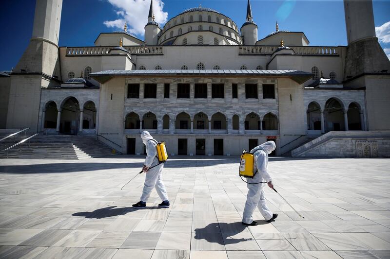 Municipality workers in protective suits disinfect the courtyard of the Kocatepe Mosque to prevent the spread of the coronavirus disease, during the holy fasting month of Ramadan in Ankara, Turkey. Reuters