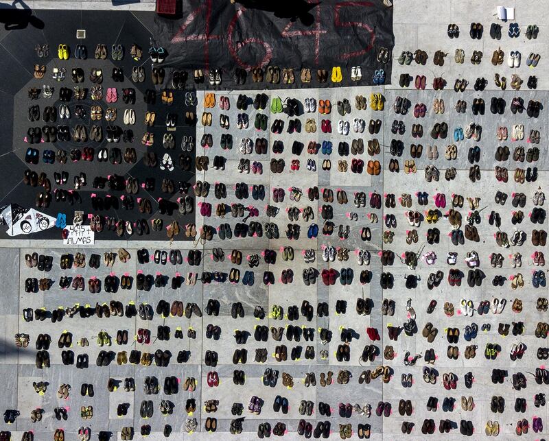 A sign reads "4645" near empty shoes outside the Capitol building in this aerial photograph taken during a protest against the government's reporting of the death toll from  Hurricane Maria in San Juan, Puerto Rico. Xavier Garcia / Bloomberg