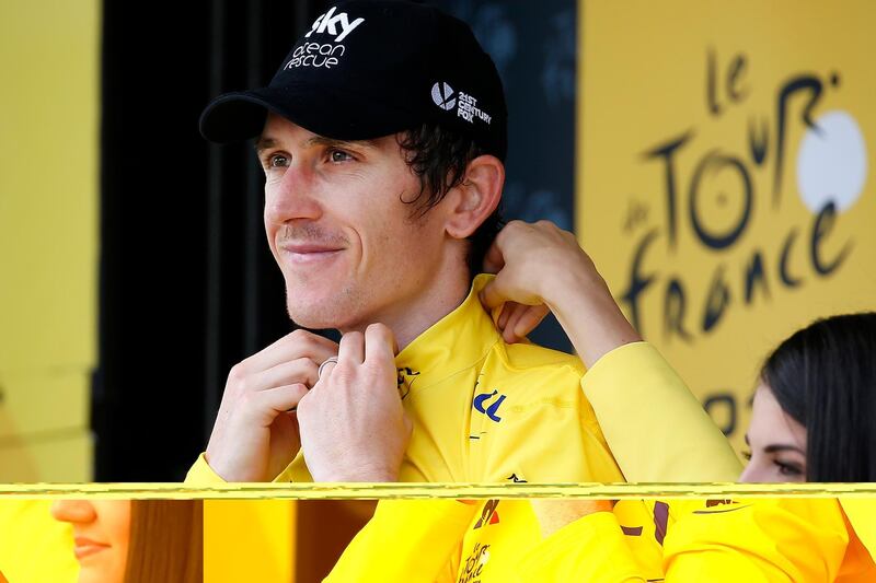 epa06916312 Team Sky rider Geraint Thomas of Britain celebrates on the podium retaining the overall leader's yellow jersey following the 20th stage of the 105th edition of the Tour de France cycling race, an individual time trial over 31km between Saint-Pee-sur-Nivelle and Espelette, France, 28 July 2018.  EPA/SEBASTIEN NOGIER