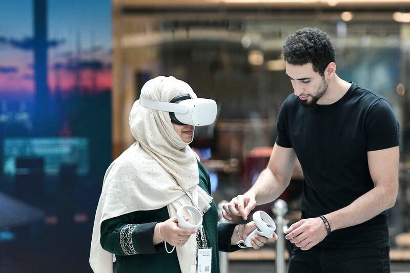 Visitors test VR headsets at the Dubai Metaverse Assembly at Museum of Future. Khushnum Bhandari / The National

