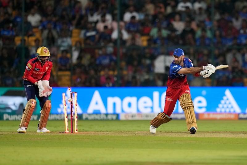 Royal Challengers Bengaluru's Glenn Maxwell is bowled out by Punjab Kings' Harpreet Brar for three runs. AP 