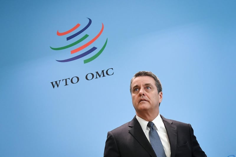World Trade Organization (WTO) director-general Roberto Azevedo looks on under a WTO sign during a press conference on April 12, 2018 at their headquarters in Geneva.
The World Trade Organization releases today its latest forecasts as trade tensions between the United States and China ratchet up. / AFP PHOTO / Fabrice COFFRINI