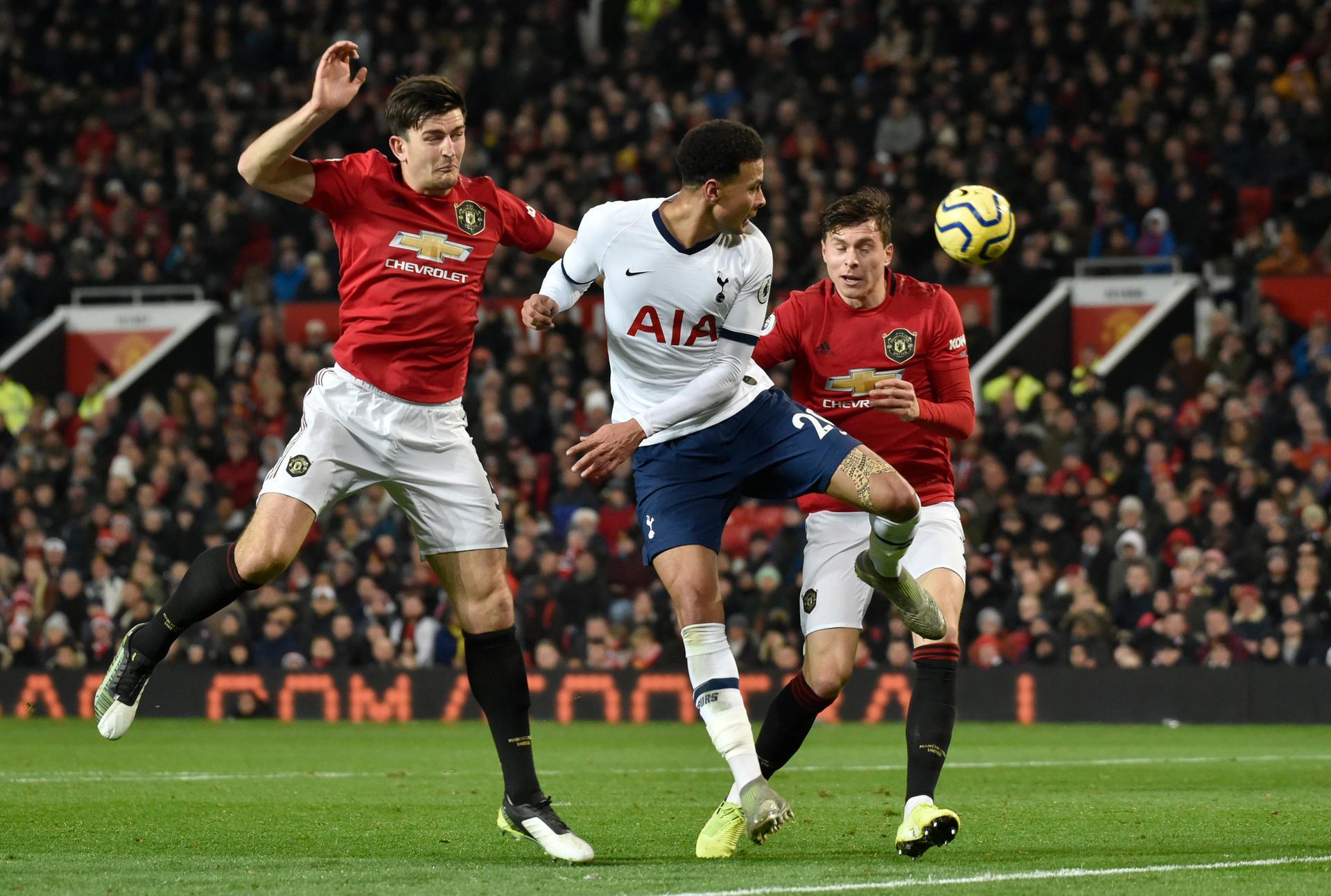 Harry Maguire, left, Dele Alli, centre, and Victor Lindelof challenge for the ball. AP Photo