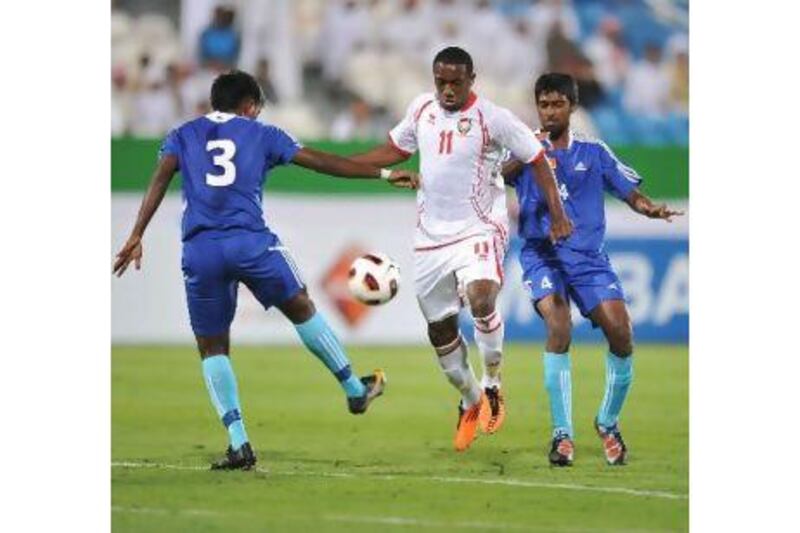 Ahmed Khalil, centre, the UAE striker, in action against Sri Lanka last night. Courtesy of Al Ittihad newspaper