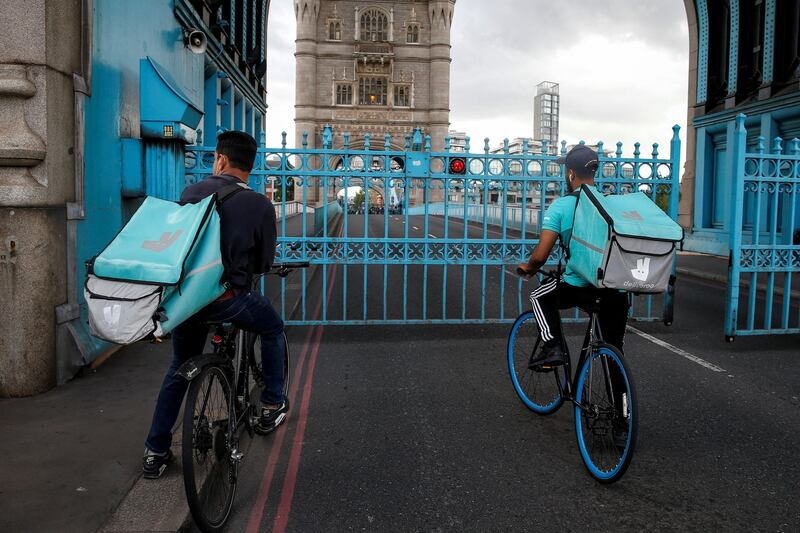 LONDON, ENGLAND - AUGUST 22: Deliveroo riders stuck on Tower Bridge on August 22, 2020 in London, England. Tower Bridge was closed this afternoon to due a mechanical fault. The bridge was reopened to pedestrians and cyclists just after 5:45pm. (Photo by Hollie Adams/Getty Images)