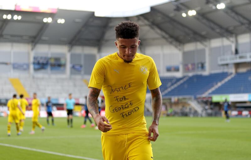 Jadon Sancho of Dortmund celebrates after scoring his teams second goal  with a 'Justice for George Floyd' shirt, which earned him a booking. EPA