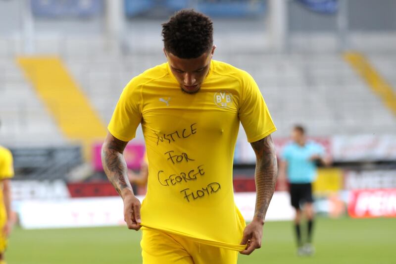 Jadon Sancho of Borussia Dortmund celebrates scoring his teams second goal of the game with a 'Justice for George Floyd' shirt. Getty