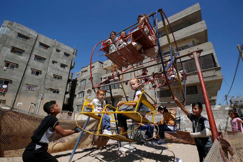 Palestinian children ride a ferris wheel during the Eid al-Fitr holiday at the Beach refugee camp in Gaza City. Reuters