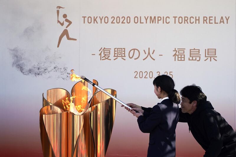 A local student lights the Olympic Flame in March, during the "Flame of Recovery" display ceremony in Iwaki, Fukushima. AP