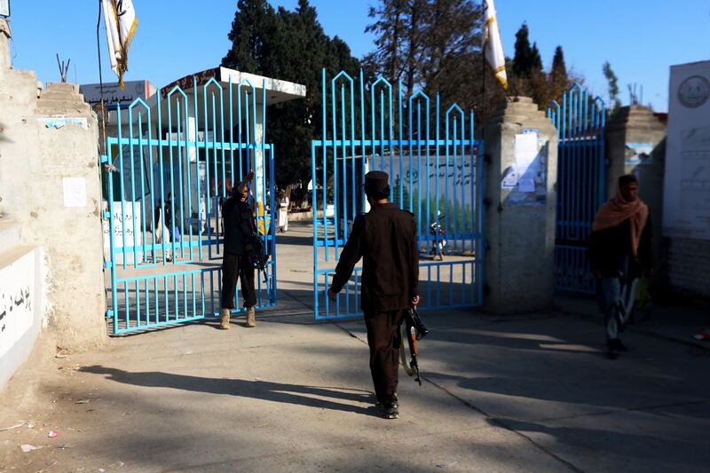 Taliban security personnel stand guard at the entrance gate of a university in Jalalabad. AFP