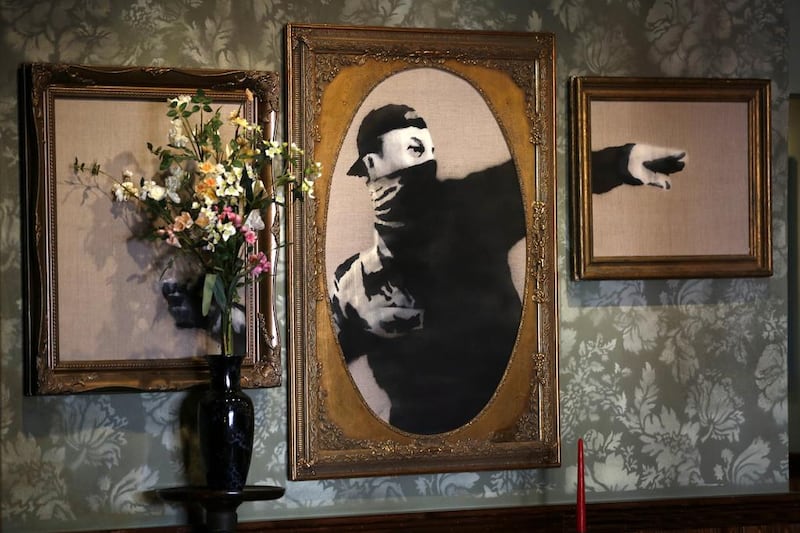 Artworks of British street artist Banksy is displayed in the Walled Off Hotel in the West Bank city of Bethlehem. Abed Al Hashlamoun / EPA