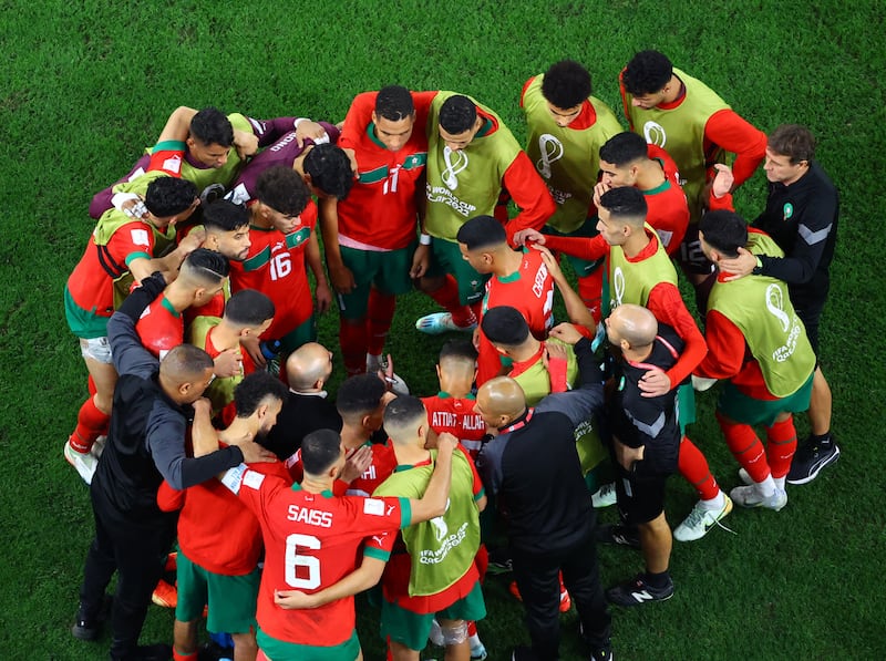 Morocco's players huddle before extra time after it ended goalless in 90 minutes. Reuters