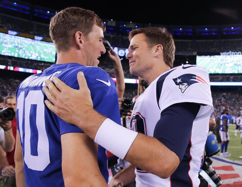 Aug 30, 2018; East Rutherford, NJ, USA; New York Giants quarterback Eli Manning (10) shakes hands with New England Patriots quarterback Tom Brady (12) after their game at MetLife Stadium. Mandatory Credit: Vincent Carchietta-USA TODAY Sports