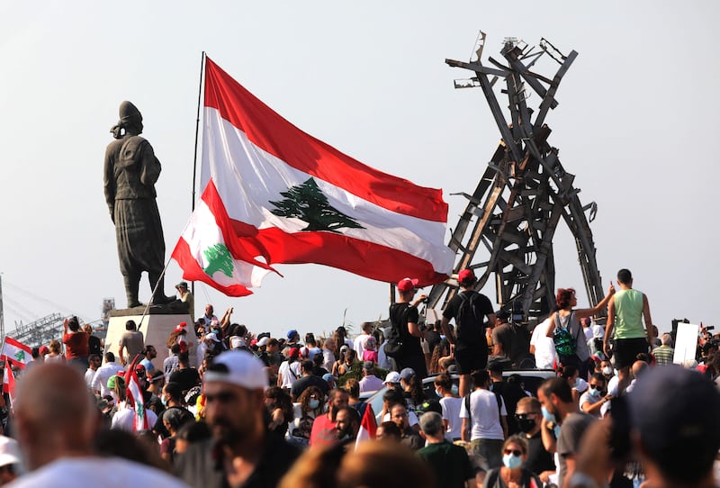 Demonstrators gather outside Beirut port on the anniversary of the blast that ravaged the city last August. Hundreds of Lebanese marched on August 4 to mark the explosion, protesting against impunity over the country's worst peacetime disaster at a time when its economy was already in tatters.