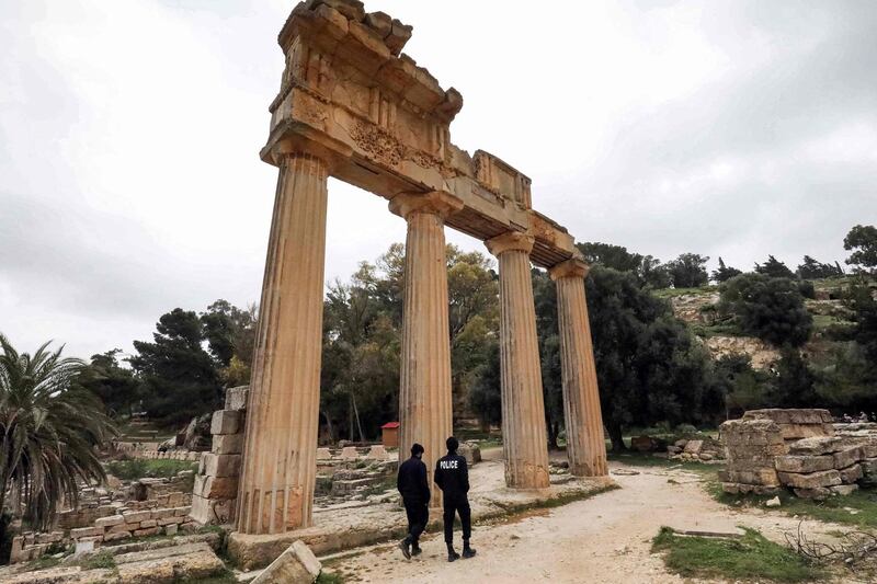 Policemen patrol by a colonnade from the remnants of the Temple of Demeter in the ruins of Libya's ancient eastern city of Cyrene.  AFP