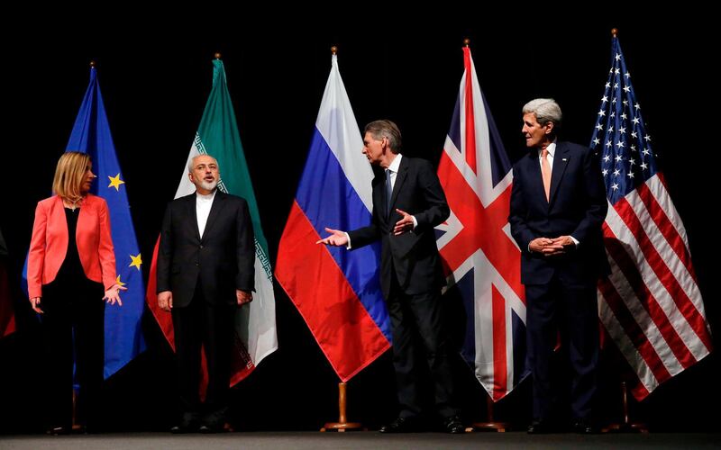 (FILES) This file photo taken on July 14, 2015 shows then British Foreign Secretary Philip Hammond (2nd R), then US Secretary of State John Kerry (R) and European Union High Representative for Foreign Affairs and Security Policy Federica Mogherini (L) talking to Iranian Foreign Minister Mohammad Javad Zarif as they wait for the Russian Foreign Minister for a group picture at the Vienna International Center in Vienna, Austria, after reaching a nuclear deal. Israel welcomes a German push to expand the Iran nuclear deal into a broader security agreement once Joe Biden moves into the White House next month, its ambassador to Berlin told AFP. Jeremy Issacharoff, the nation's envoy in Germany since 2017, said a recent call by German Foreign Minister Heiko Maas to reassess the 2015 nuclear accord with a new US administration was a "step in the right direction". / AFP / POOL / CARLOS BARRIA / TO GO WITH AFP INTERVIEW by DEBORAH COLE on December 24, 2020
