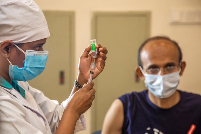 epa08970507 A health worker prepares to administer a Oxford-AstraZeneca developed vaccine produced by the Serum Institute of India (SII) during the 2nd day of vaccination campaign at the Bangabandhu Sheikh Mujib Medical University (BSMMU) in Dhaka, 28 January, 2021. According to the Bangladesh Health authority, the vaccination program for Covid-19 on trial has begun at five government hospitals across the Dhaka city.  EPA/MONIRUL ALAM