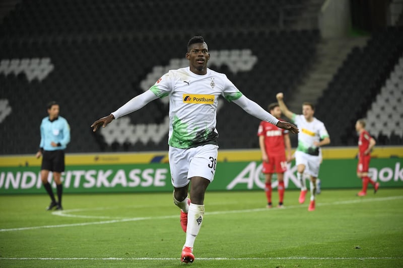 Moenchengladbach's Swiss forward Breel Embolo celebrates scoring the opening goal during the German first division Bundesliga football match Borussia Moenchengladbach v 1 FC Cologne in Moenchengladbach, western Germany on March 11, 2020. - Rhine Bundesliga derby between Borussia Moenchengladbach and Cologne, will be held behind closed doors due to the coronavirus, the first game in Bundesliga history to be played without fans. (Photo by Ina FASSBENDER / AFP) / DFL REGULATIONS PROHIBIT ANY USE OF PHOTOGRAPHS AS IMAGE SEQUENCES AND/OR QUASI-VIDEO