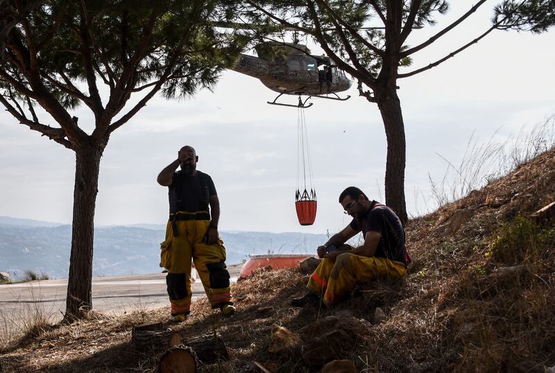 Exhausted firefighters take a well-earned rest.