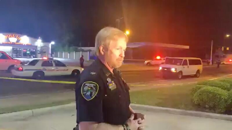 A police representative speaks in the aftermath of a drive-by shooting at a liquor store in Shreveport, Louisiana. Reuters