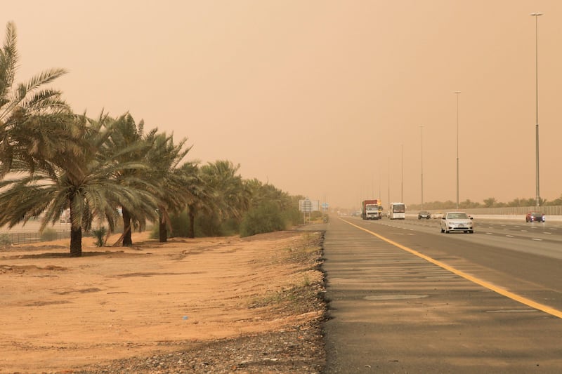 Dubai, United Arab Emirates - April 7 2013 - Motorists drive through intermittent heavy rains and a sandstorm off Emirates Road.  tags: WEATHER (Razan Alzayani / The National)