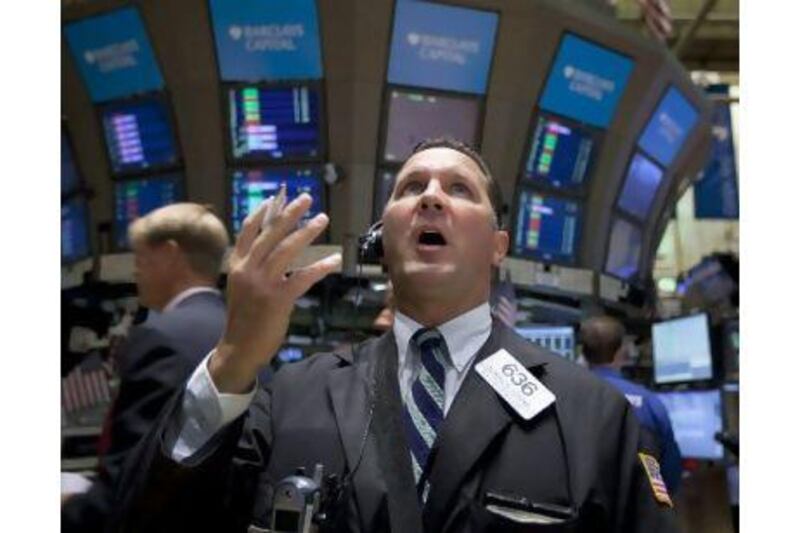 A trader reacts at the New York Stock Exchange yesterday after stocks fell despite a report that hiring in the US improved in July.