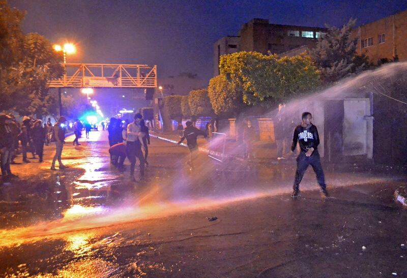 Lebanese security forces use a water cannon to disperse protesters outside the Serail, headquarters of the Governorate of North Lebanon. AFP