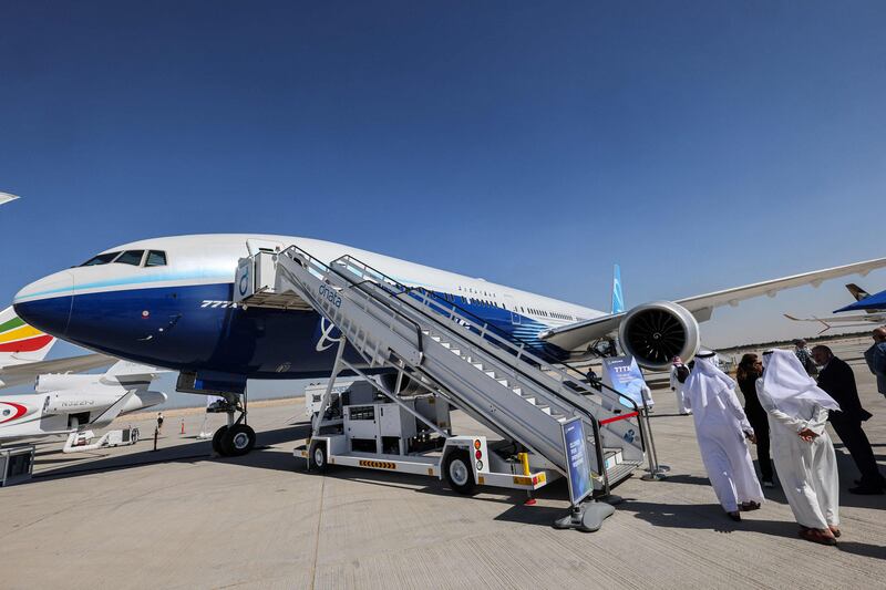 Attendees stand by the ramp leading to the Boeing 777X demonstration aircraft at the 2021 Dubai Airshow.  AFP