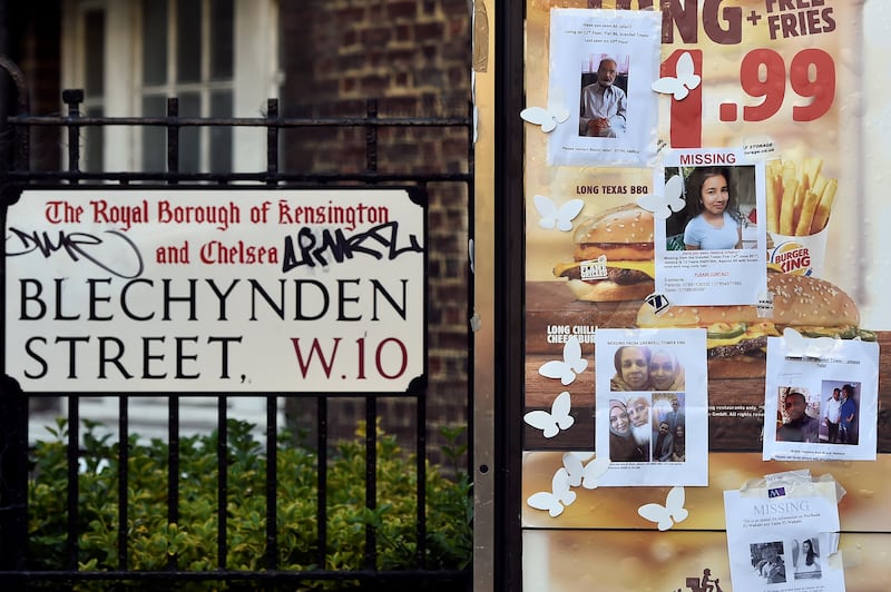 Missing persons posters were displayed in a street near the scene in the aftermath of the fire. Reuters